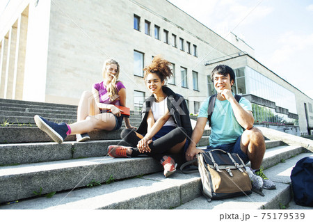 cute group of teenages at the building of university with books huggings, diversity nations, having lunch cute group of teenages at the building of university with books huggings, diversity nations, having lunch 75179539