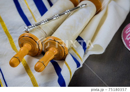 Jewish Orthodox holidays, during prayer items prayer shawl tallit with torah scroll Jewish Orthodox holidays, during prayer items prayer shawl tallit with torah scroll 75180357