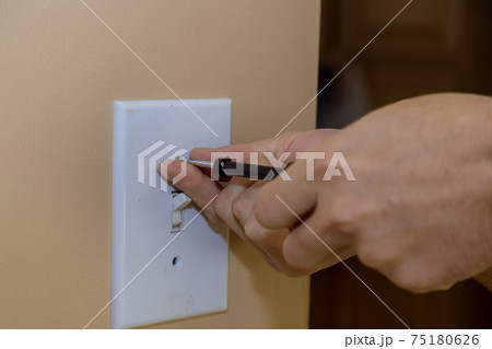 Removing wall switch cover in order to mask the outlet in preparation for painting Removing wall switch cover in order to mask the outlet in preparation for painting 75180626