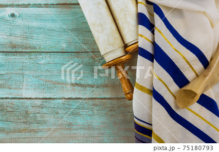 Jewish holidays, during prayer items kippa with prayer shawl tallit on shofar, torah scroll 75180793