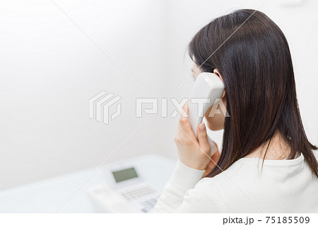 固定電話で話をする女性 75185509