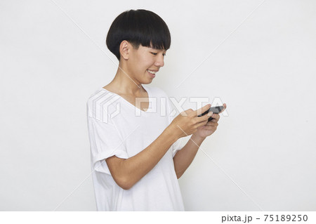 Young Asian man with a mobile phone Young Asian man with a mobile phone 75189250