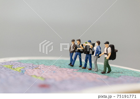 Miniature people Backpacker walking on map 75191771