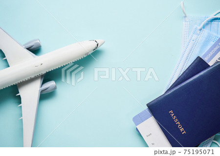 Plane mode, tickets and mask. Resuming flight travel concept due coronavirus pandemic. Plane mode, tickets and mask. Resuming flight travel concept due coronavirus pandemic. 75195071