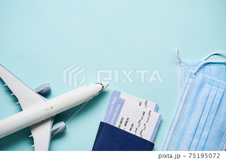 Plane mode, tickets and mask. Resuming flight travel concept due coronavirus pandemic. Plane mode, tickets and mask. Resuming flight travel concept due coronavirus pandemic. 75195072