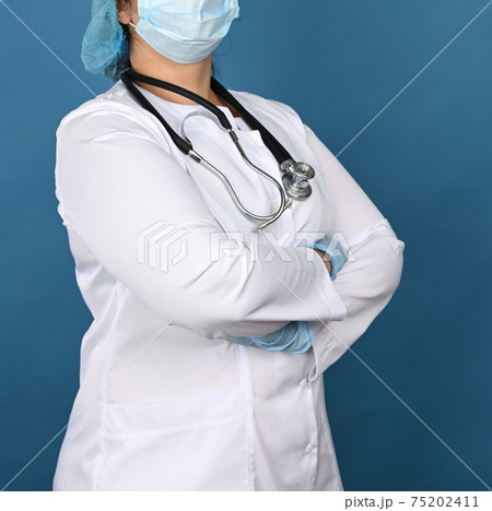 woman doctor in a white medical gown stands on a blue background, 75202411