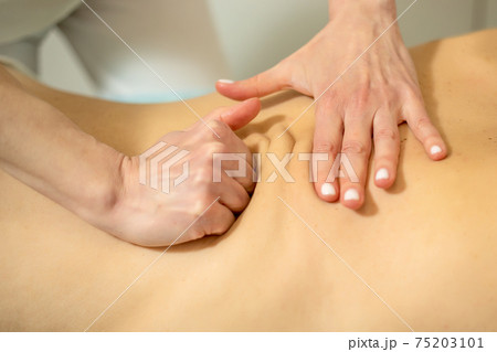 Young woman relaxing with hand massage at beauty spa. 75203101