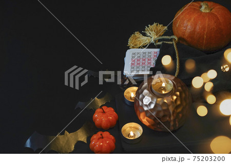 Defocused mystic ritual with tarot cards, candles. Halloween concept 75203200
