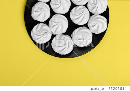 Colors yellow and gray , Color of the year of 2021 Illuminating . Marshmallow in plate Colors yellow and gray , Color of the year of 2021 Illuminating . Marshmallow in plate 75205814