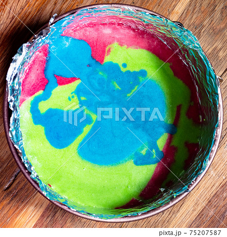 multicoloured mix of raw dough in springform pan multicoloured mix of raw dough in springform pan 75207587