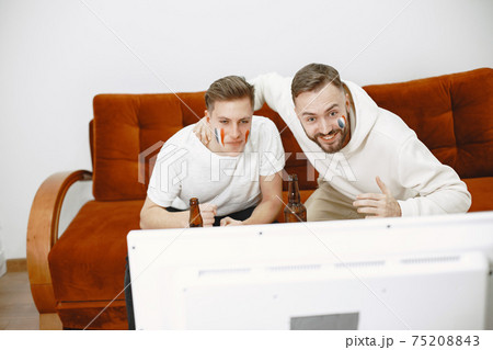 Group of fans are watching a soccer moment on the TV Group of fans are watching a soccer moment on the TV 75208843