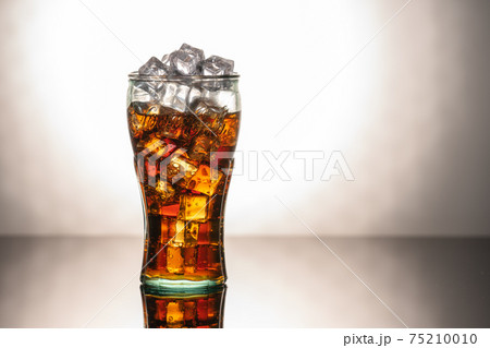 Original glass of Coca Cola with ice and Coca Cola. UK, England, March 3, 2021 75210010