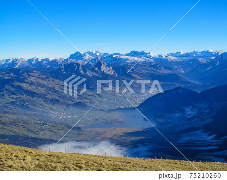 View from mount Rigi, Switzerland towards the Alps in a winter without any snow 75210260