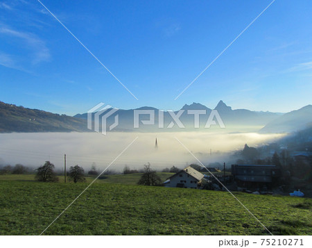 View from the slopes of mount Rigi, Switzerland towards Aarth-Goldau in the fog 75210271