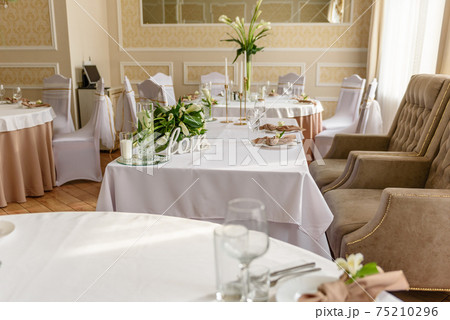 Beautiful decoration of the wedding holiday with flowers and greenery with florist decoration 75210296