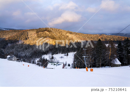 Stopped t-bar surface lift on abandoned empty ski slope, end of ski season and quarantine concept, Krkonose mountains, Czech Republic 75210641