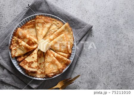 Russian thin pancakes or blini with red caviar on grey. Russian thin pancakes or blini with red caviar on grey. 75211010