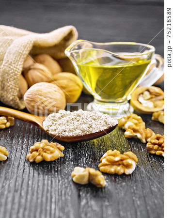 Flour walnut in spoon on wooden board 75218589