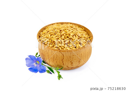 Flaxen white seed in bowl with flower Flaxen white seed in bowl with flower 75218630