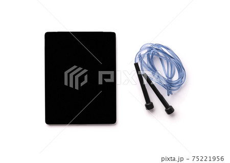 Flat lay top view jump rope and tablet with empty screen on white background Flat lay top view jump rope and tablet with empty screen on white background 75221956