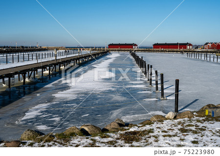 Ice covering a yacht marina. Blue sky background. Picture from Lomma, Sweden Ice covering a yacht marina. Blue sky background. Picture from Lomma, Sweden 75223980