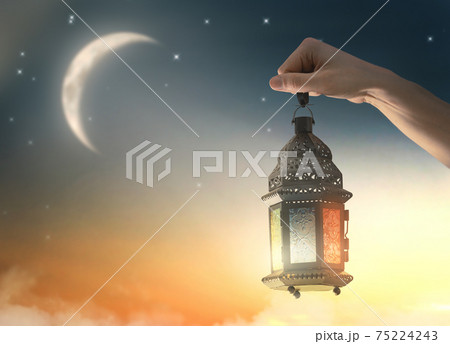 Ornamental Arabic lantern with burning candle 75224243