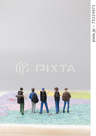 Miniature people Backpacker walking on map Miniature people Backpacker walking on map 75224971