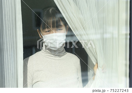 窓から外を見る女の子（外出自粛要請のイメージ） 75227243