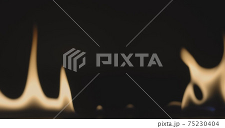 Fire dancing against dark background Fire dancing against dark background 75230404