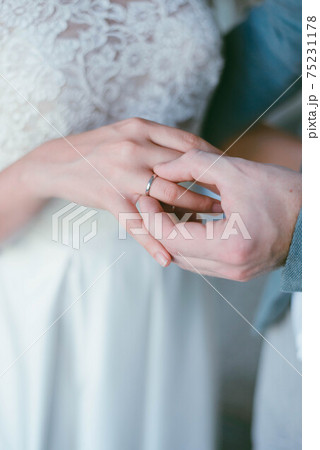 wedding ring on the finger. The groom puts the ring on the bride. wedding wedding ring on the finger. The groom puts the ring on the bride. wedding 75231178