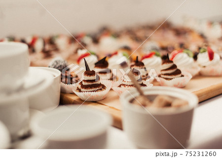 muffins and white cups. Production of muffins and pastries muffins and white cups. Production of muffins and pastries 75231260
