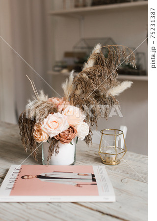 artificial decorative flowers on a wooden table. wood texture artificial decorative flowers on a wooden table. wood texture 75231387