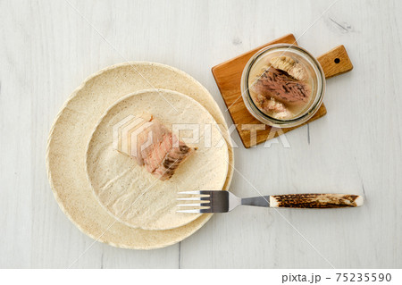 Top view of canned sturgeon on a plate. Top view of canned sturgeon on a plate. 75235590