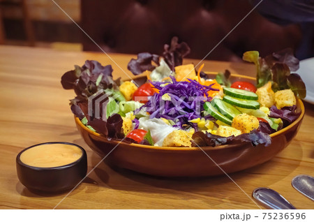 Mixed fresh vegetable salad with sauce on table, clean food concept with selective focus Mixed fresh vegetable salad with sauce on table, clean food concept with selective focus 75236596