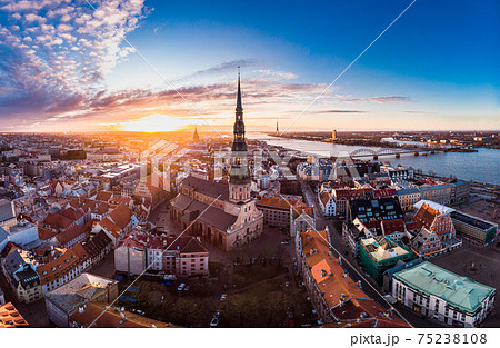 Aerial panoramic view to histirical center Riga, quay of river Daugava. Famous Landmark - st. Peter's Church's tower and City Dome Cathedral church, Old Town Monument. Latvia, Europe. shot from drone 75238108