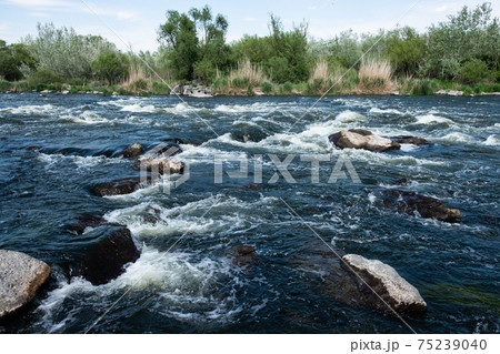 Rocky landscape on Southern Bug River with rapids. Ukraine Rocky landscape on Southern Bug River with rapids. Ukraine 75239040