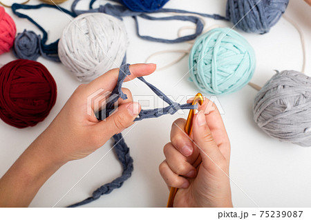 Children's hands are crocheted and thread. View from above Children's hands are crocheted and thread. View from above 75239087