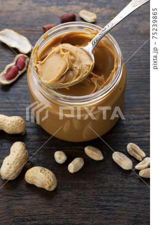 peanut paste in an open jar and peanuts in the peel peanut paste in an open jar and peanuts in the peel 75239865