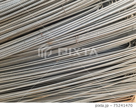 Stack of heavy metal reinforcement bars with periodic profile texture. Close up steel construction armature. Abstract industrial background concept. Copy space. Stack of heavy metal reinforcement bars with periodic profile texture. Close up steel construction armature. Abstract industrial background concept. Copy space. 75241470