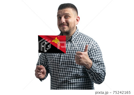 White guy holding a flag of Papua New Guinea and shows the class by hand isolated on a white background. Like for Papua New Guinea 75242165