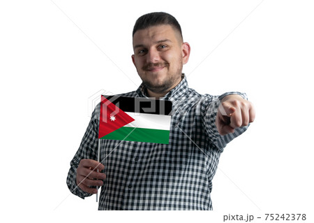 White guy holding a flag of Jordan and points forward in front of him isolated on a white background White guy holding a flag of Jordan and points forward in front of him isolated on a white background 75242378