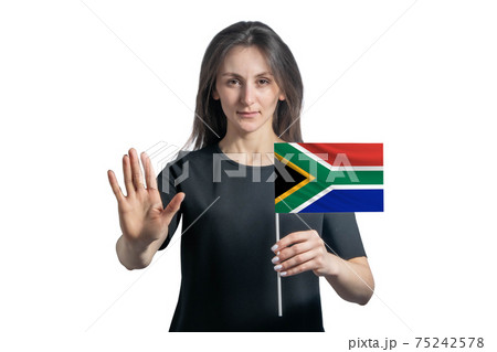 Happy young white woman holding flag of South African Republic and with a serious face shows a hand stop sign isolated on a white background 75242578