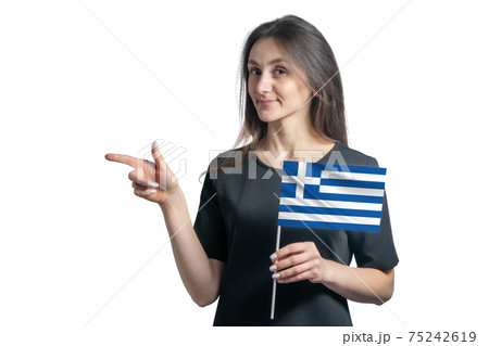 Happy young white woman holding flag Greece and points to the left isolated on a white background 75242619