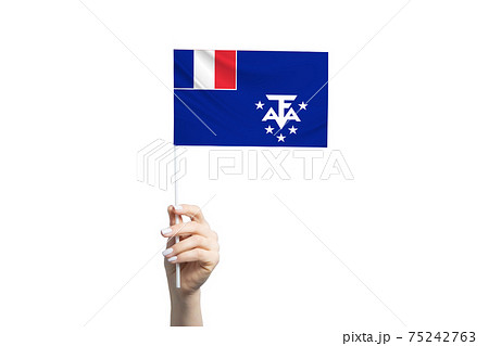 Beautiful female hand holding French Southern and Antarctic Territories flag, isolated on white background Beautiful female hand holding French Southern and Antarctic Territories flag, isolated on white background 75242763
