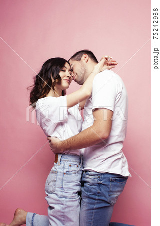young cheerful caucasian couple together having fun on pink background, guy ang girl modern relationship, lifestyle people concept young cheerful caucasian couple together having fun on pink background, guy ang girl modern relationship, lifestyle people concept 75242938
