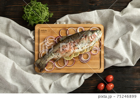 baked rainbow trout on a wooden board for serving baked rainbow trout on a wooden board for serving 75246899