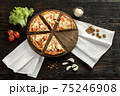 Delicious pizza on a wooden cutting board 75246908