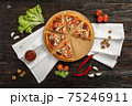 Delicious pizza on a wooden cutting board 75246911