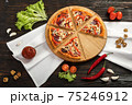 Delicious pizza on a wooden cutting board 75246912