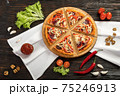 Delicious pizza on a wooden cutting board 75246913